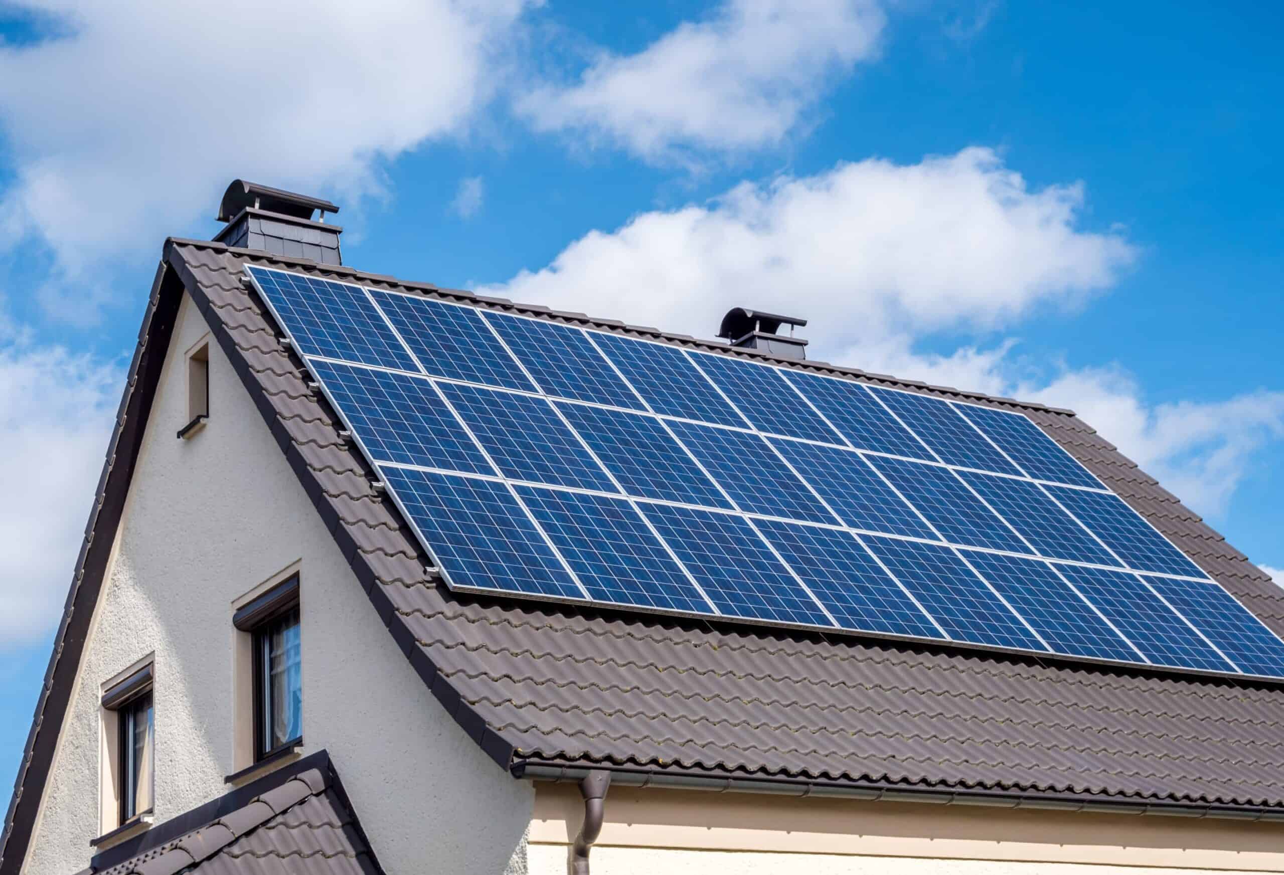 white-home-scallop-roof-and-solar-panels-shutterstock-1336991930-scaled-1-scaled